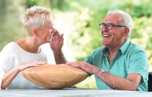elderly person holding CRDL with his carer