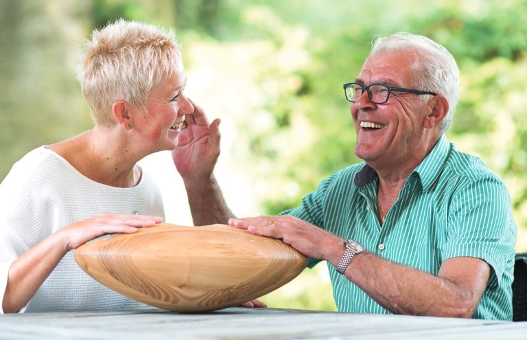 elderly person holding CRDL with his carer