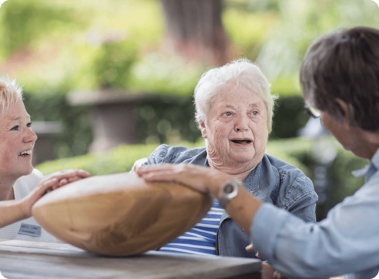 one elderly people and 2 carers holding crdl