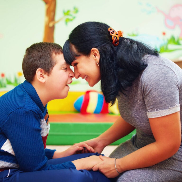 soulful moment. portrait of mother and her beloved son with disability in rehabilitation center